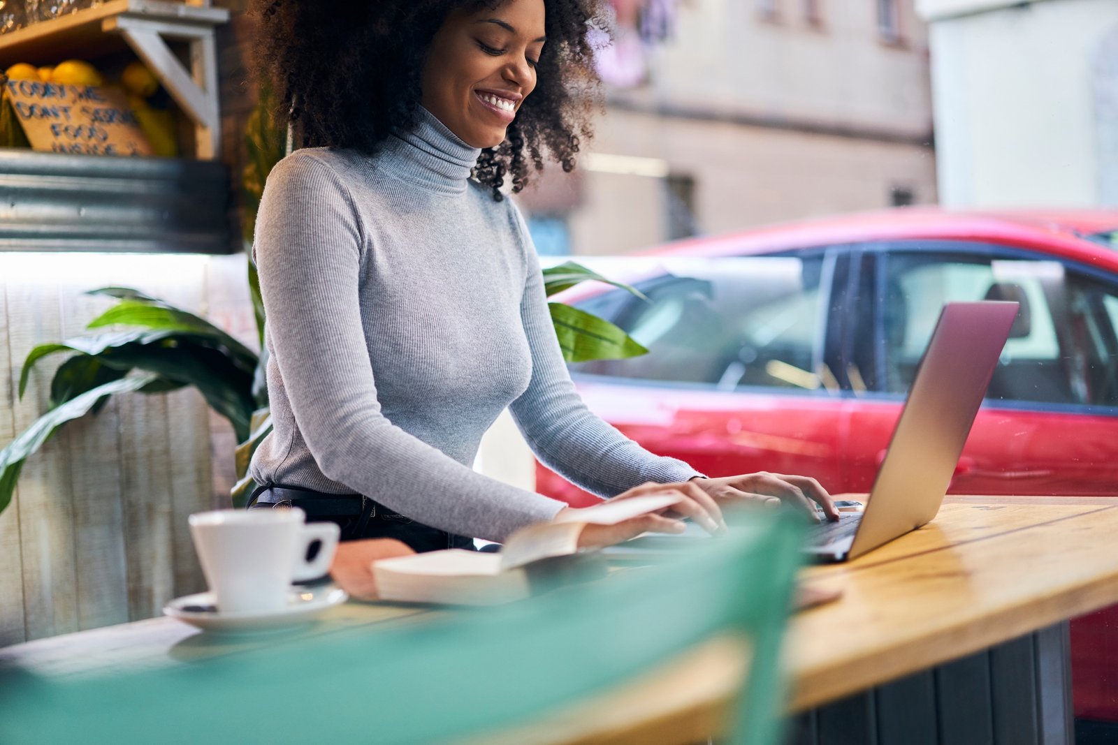 Happy black woman using laptop